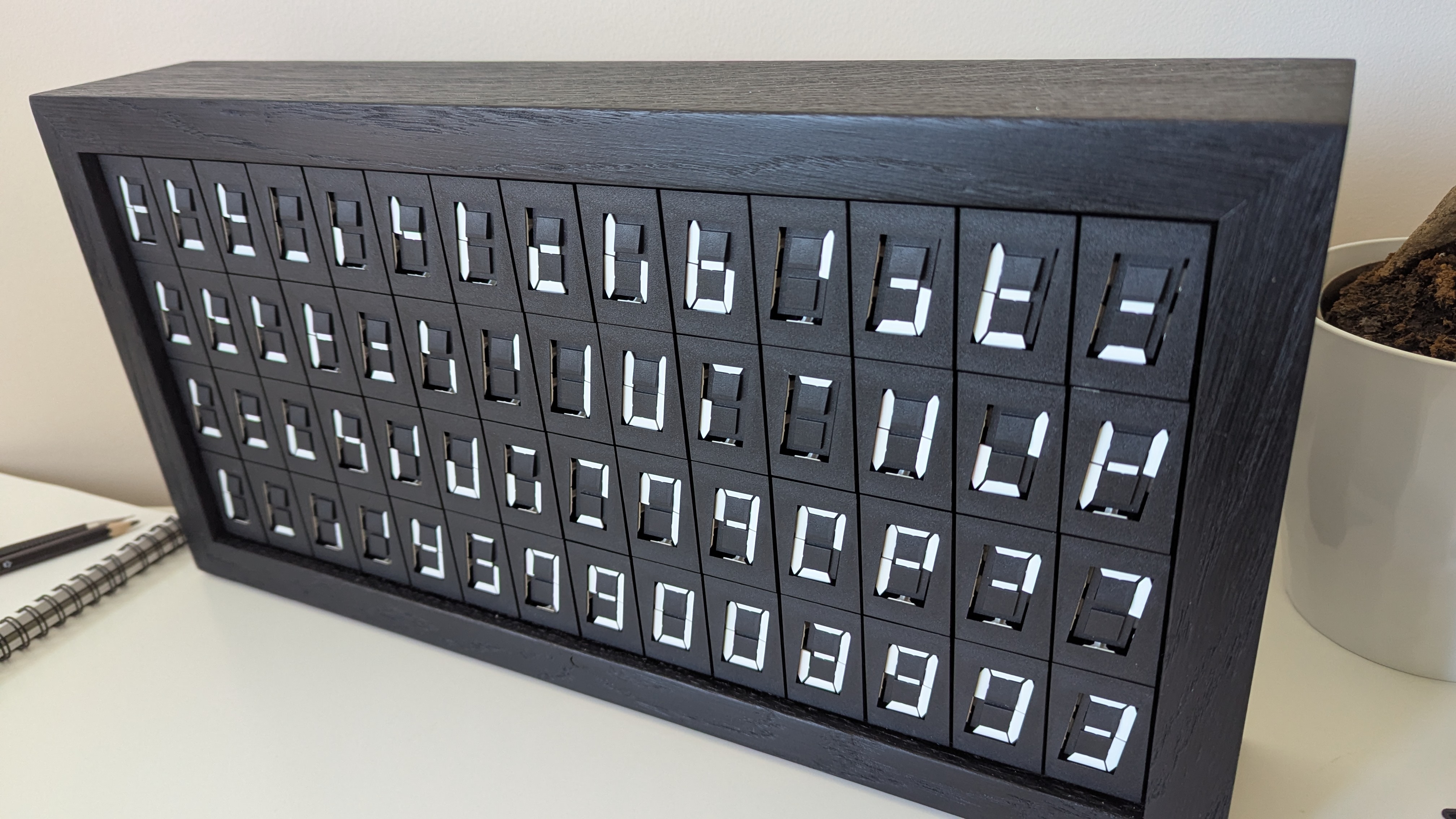Box of Digits artwork displayed in a dark framed installation